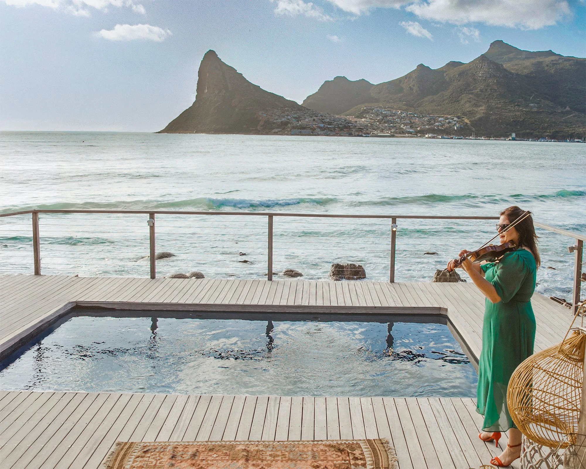Cape Town violinist Larah Eksteen performing at Tintswalo Atlantic with ocean and mountain views in Hout Bay.