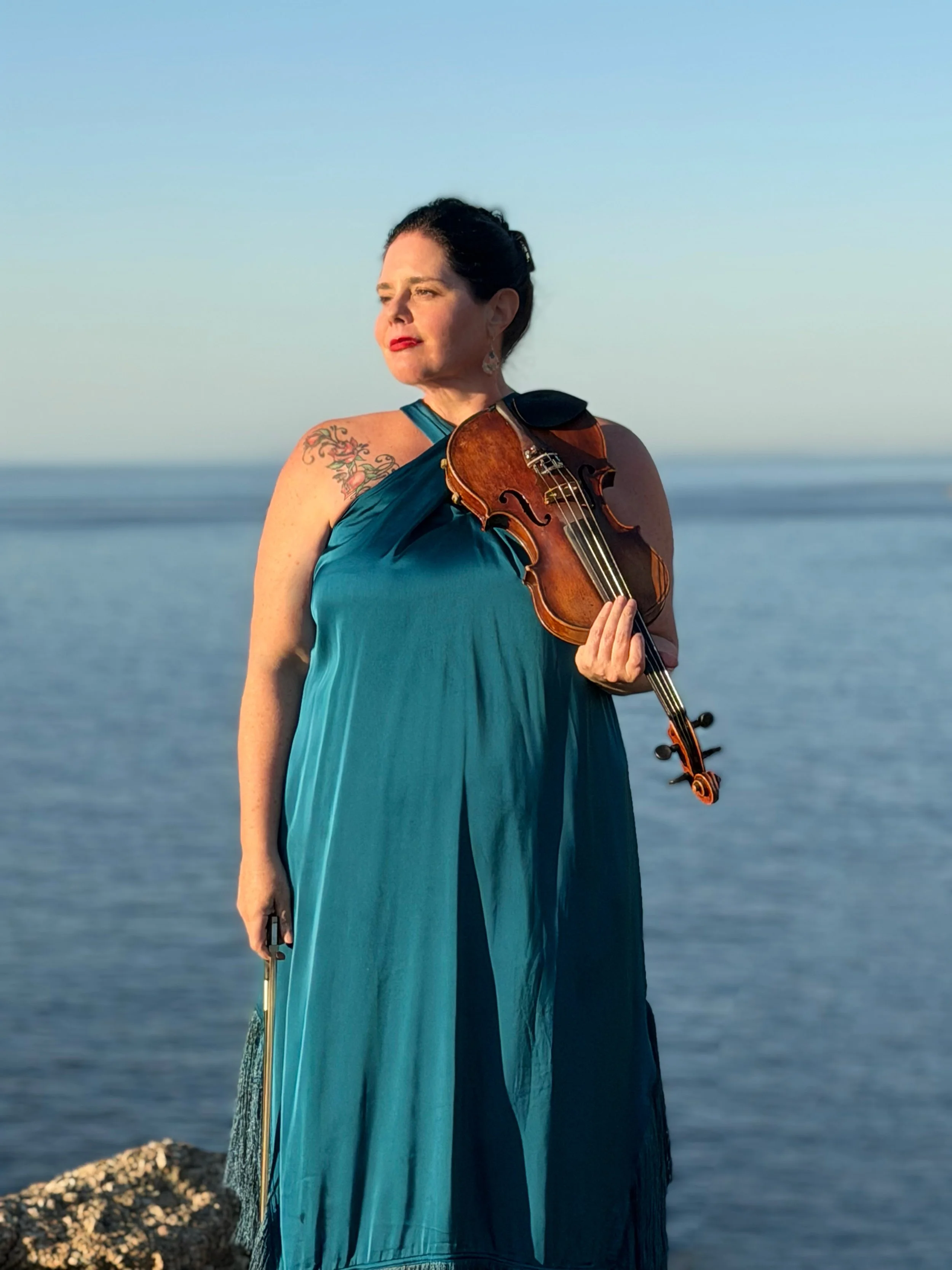 Cape Town wedding violinist Larah Eksteen with acoustic violin overlooking the Atlantic Ocean.