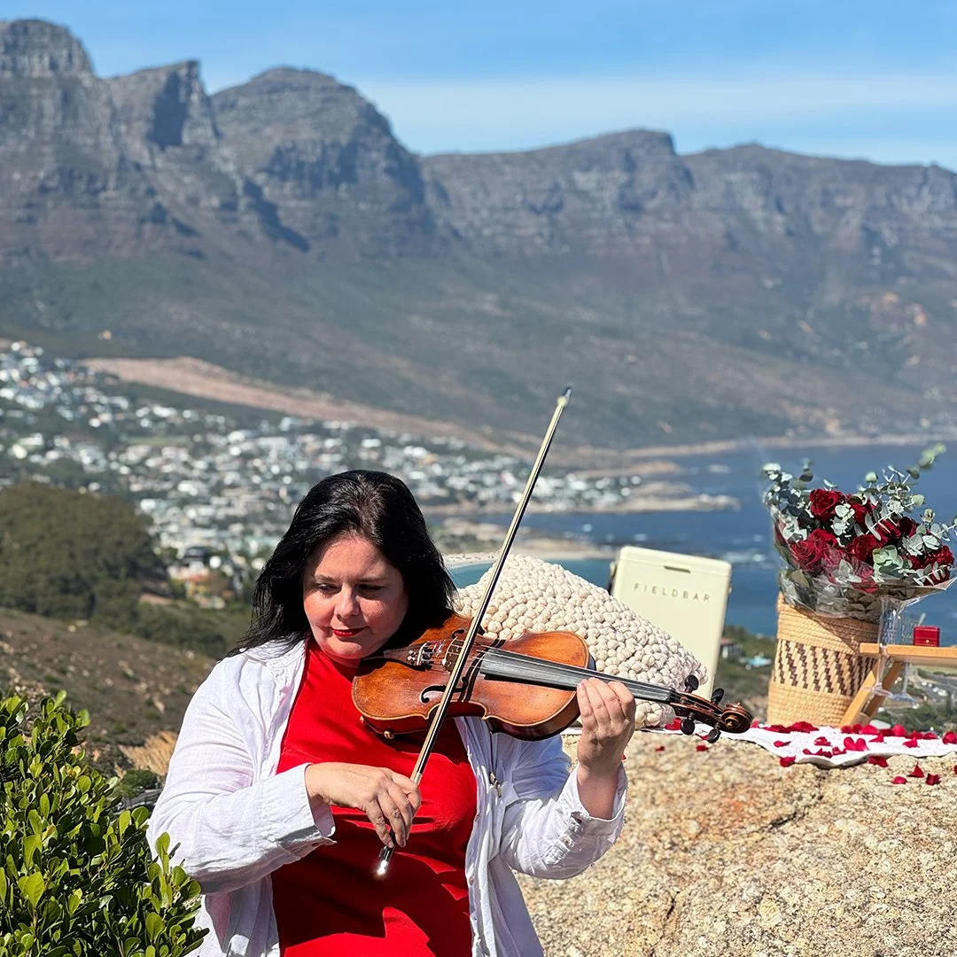 Live violin for a romantic luxury proposal overlooking Camps Bay and the Atlantic coastline