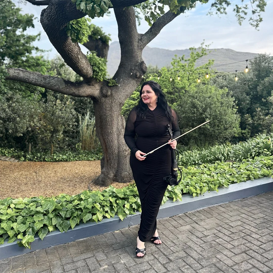 Electric violinist performing at The Conservatory in Franschhoek surrounded by Cape Winelands scenery and mountain views.