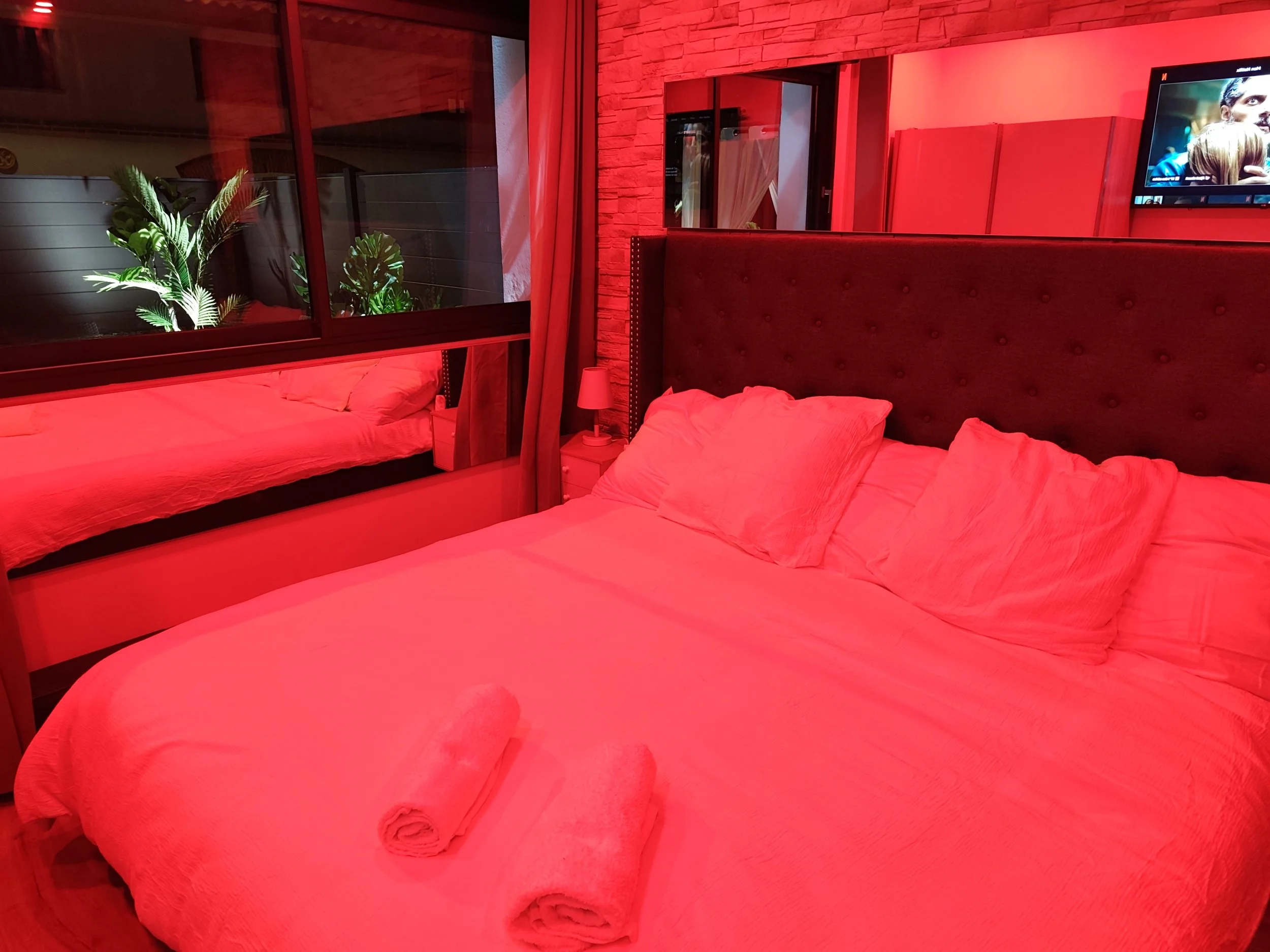 Suite love room avec grand lit XXL et décoration sensuelle à la Villa Donuts