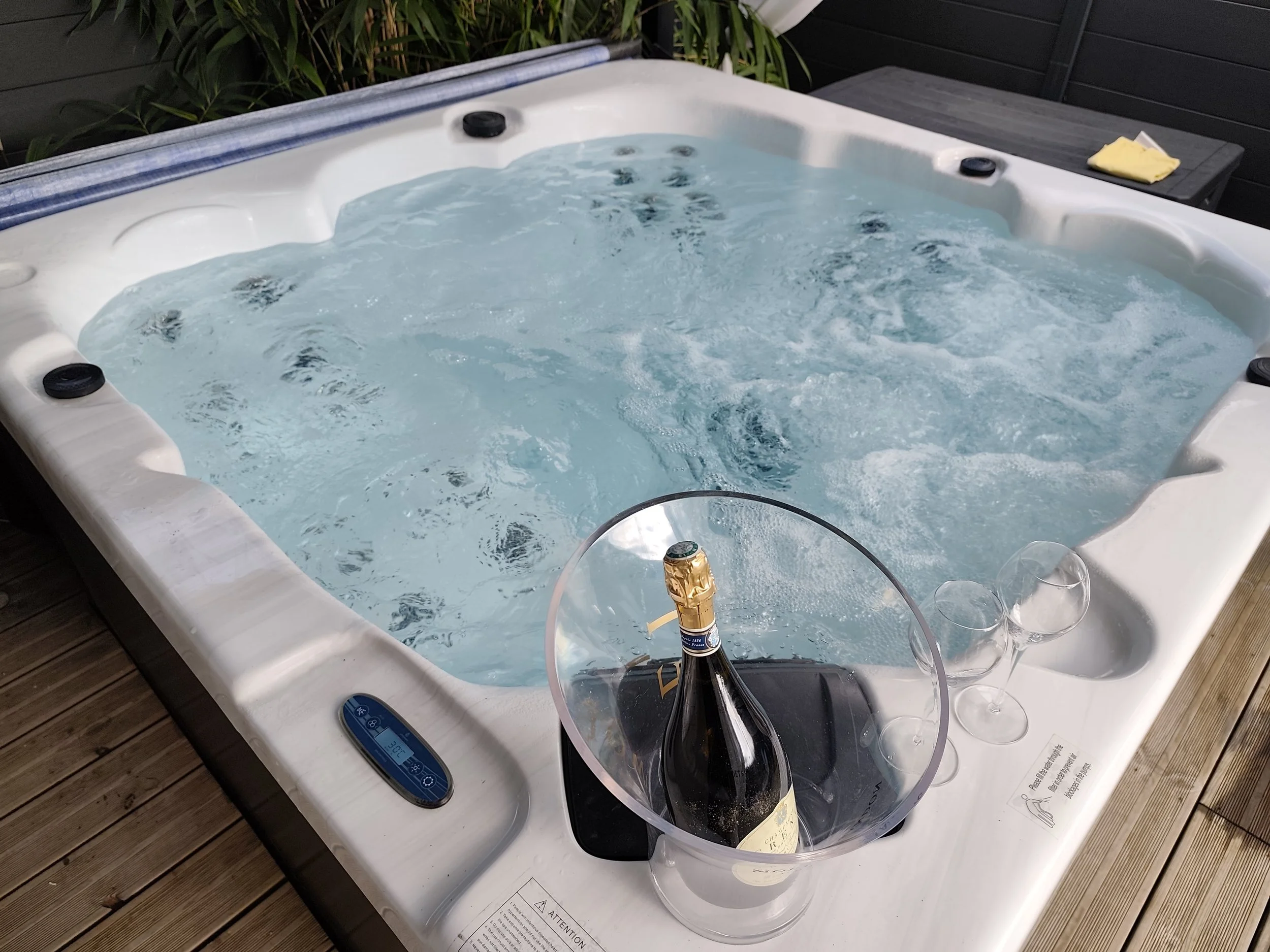 Champagne au bord du jacuzzi dans la love room Villa Donuts pour une nuit romantique