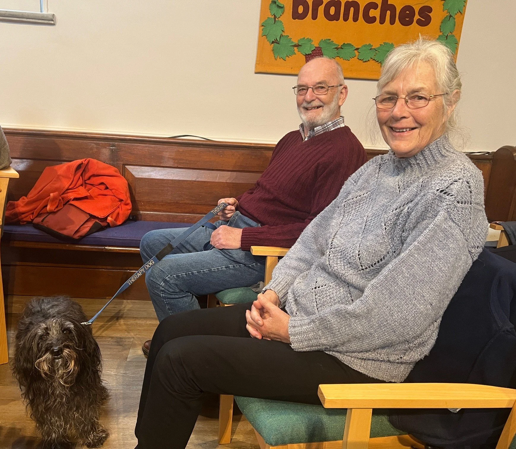 two people in church with their dog