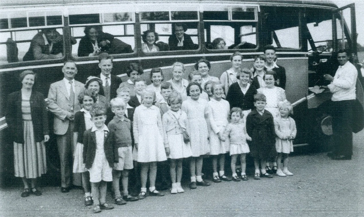 Children standing by a coach