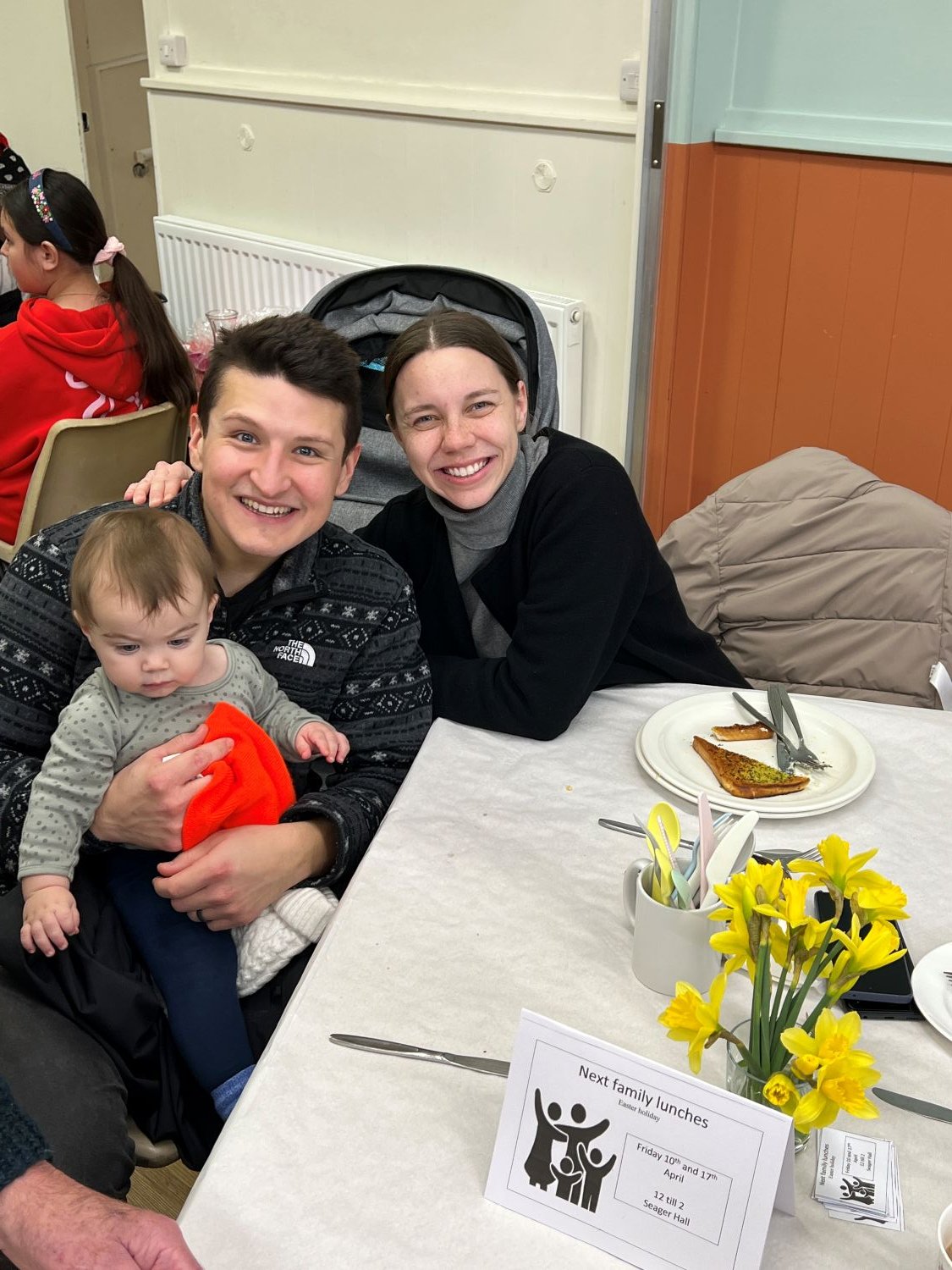 family of 3 at lunch table