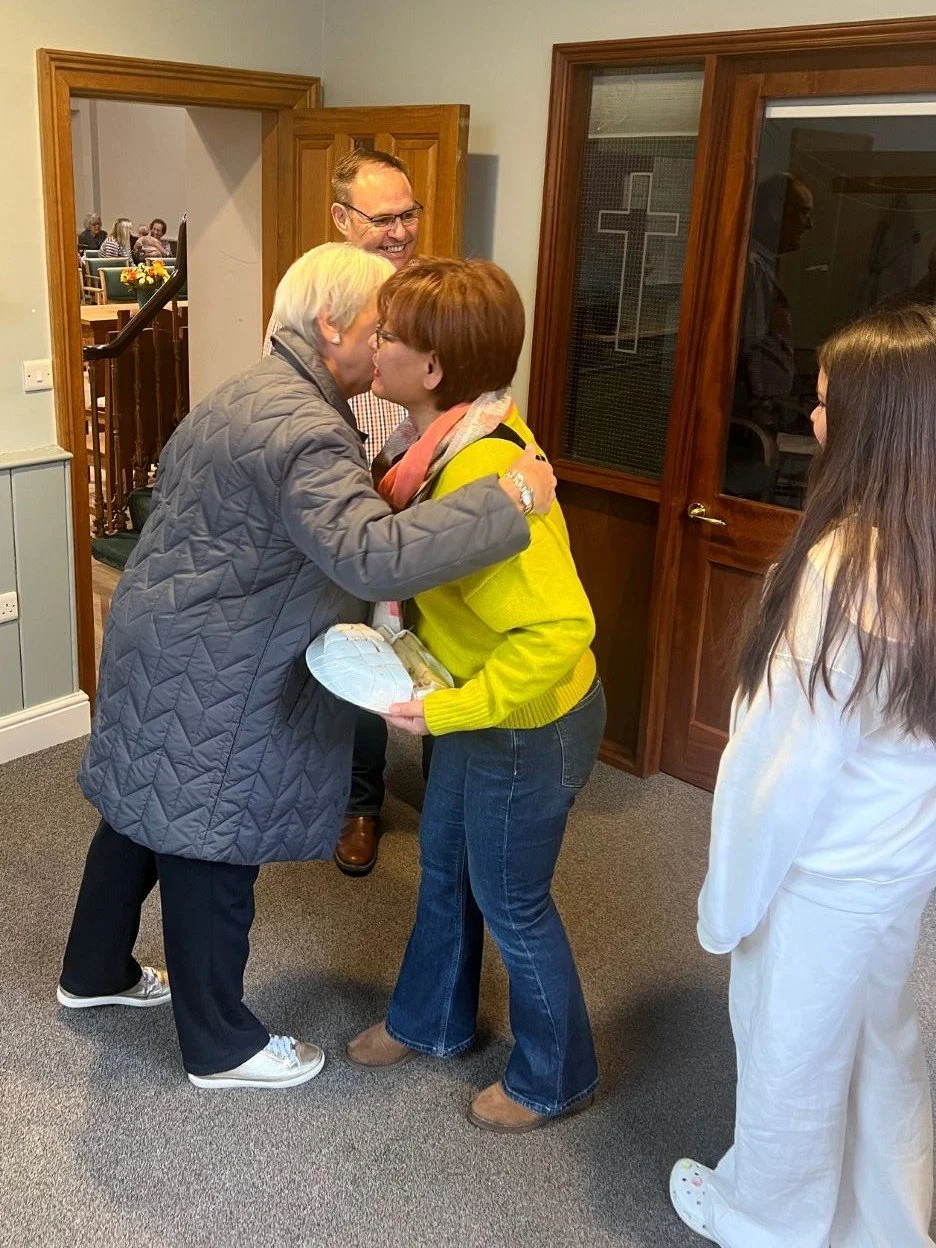 people arriving at church being greeted