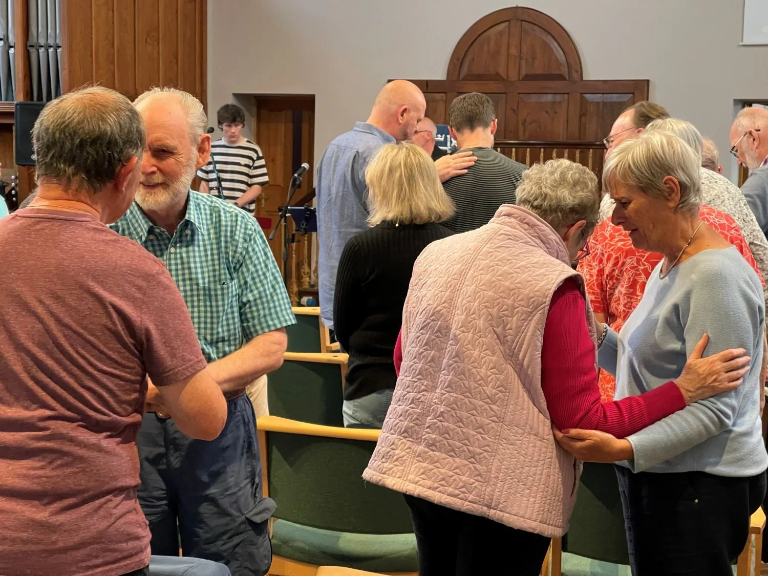 people praying for each other in pairs