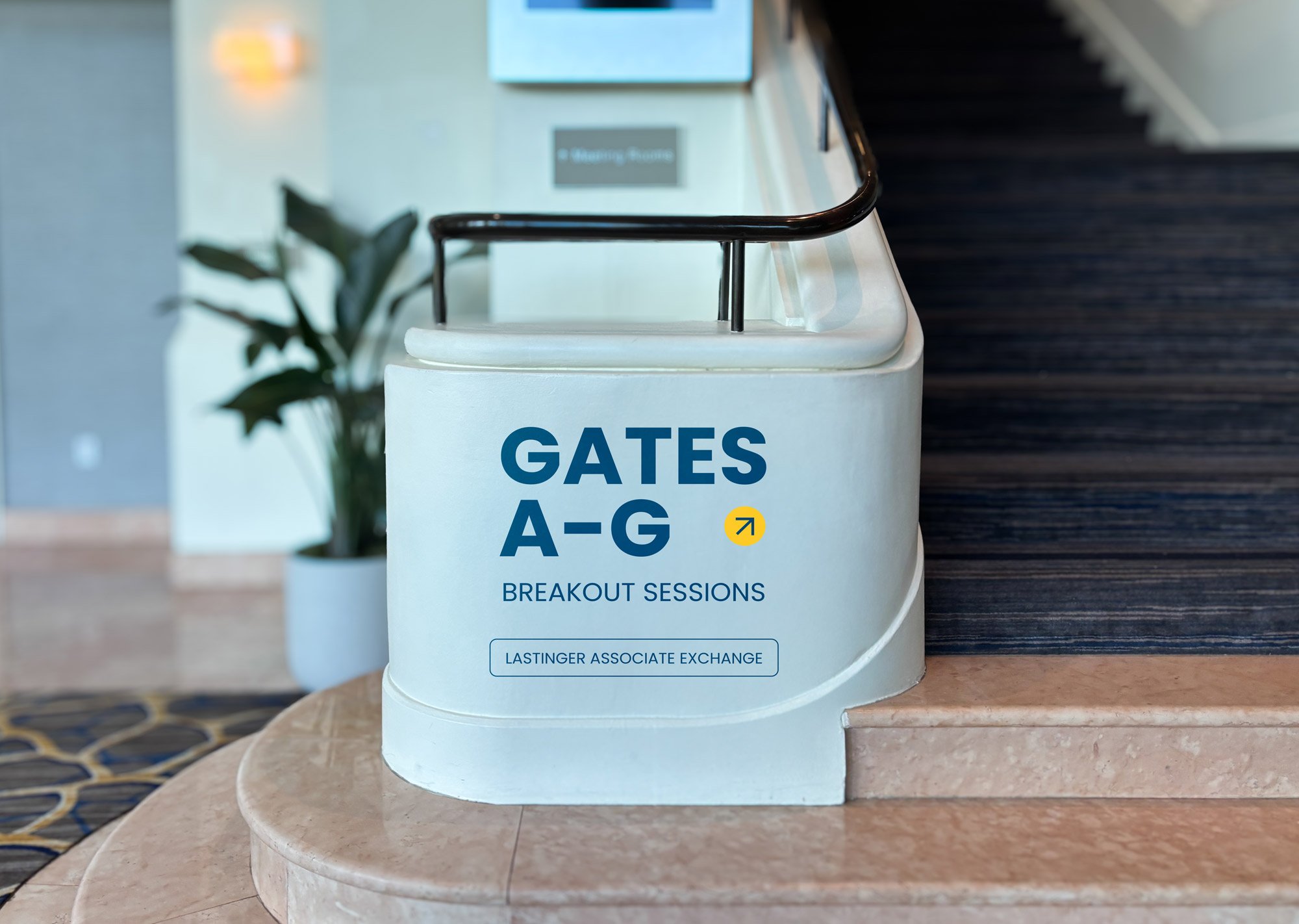 Sign indicating gates A to G for breakout sessions at the Lastinger Associate Exchange in a conference center.