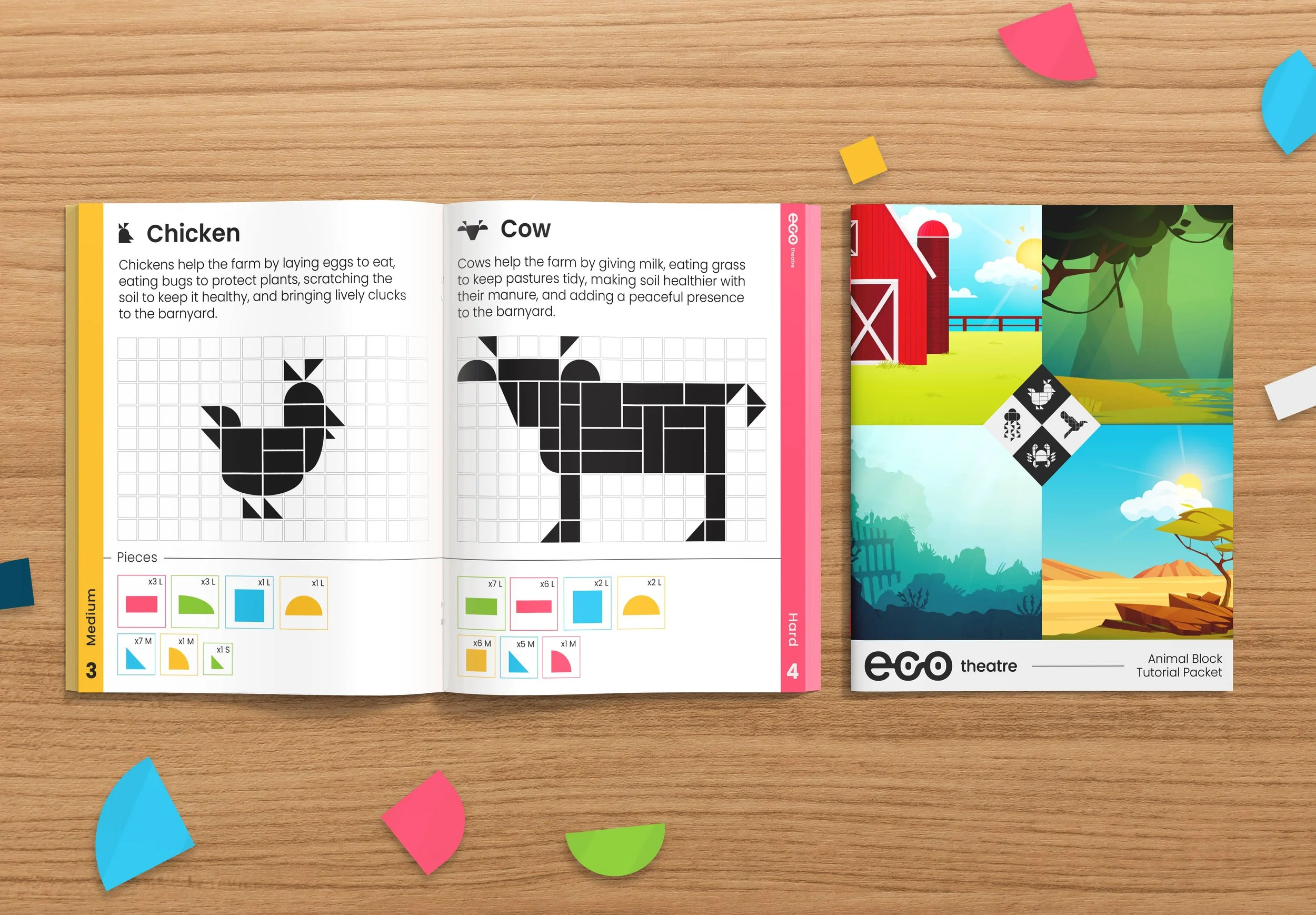 Open activity book with pixel art of chicken and cow on left pages, colorful pieces of paper scattered on wooden surface, and animal themed activity booklet on right.