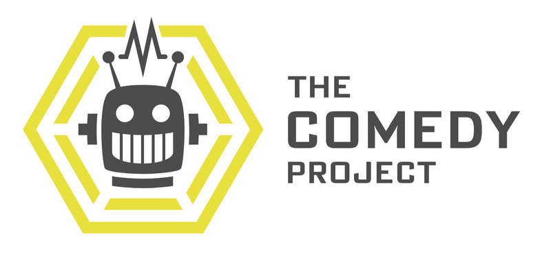Logo of The Comedy Project featuring a cartoon robot skull inside a yellow hexagon.