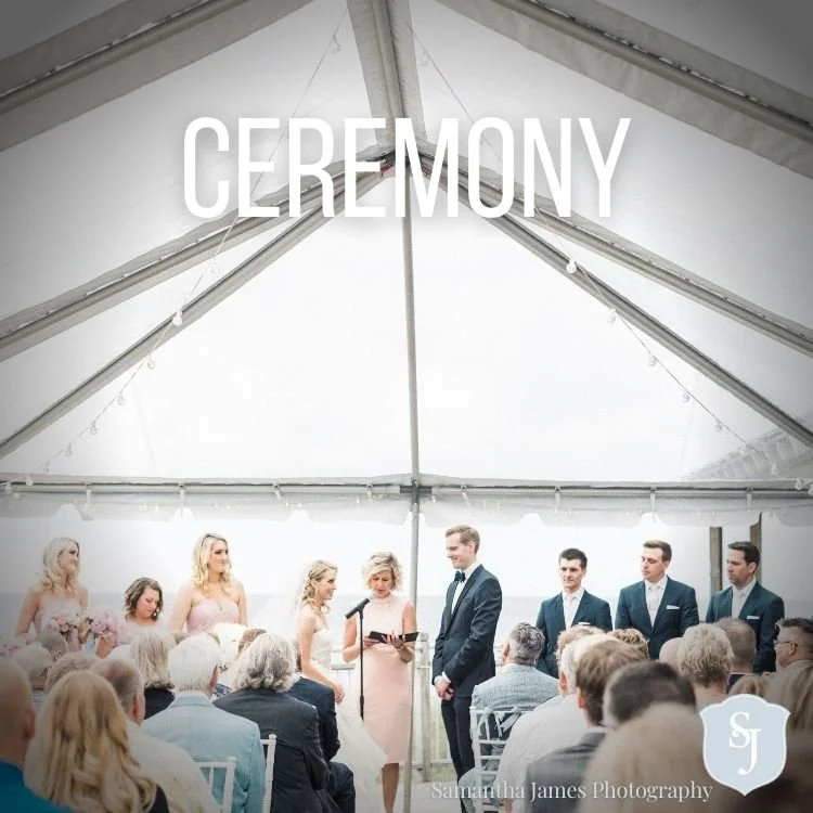 A wedding ceremony under a large white tent, with bridesmaids and groomsmen standing before the couple, and guests seated watching.