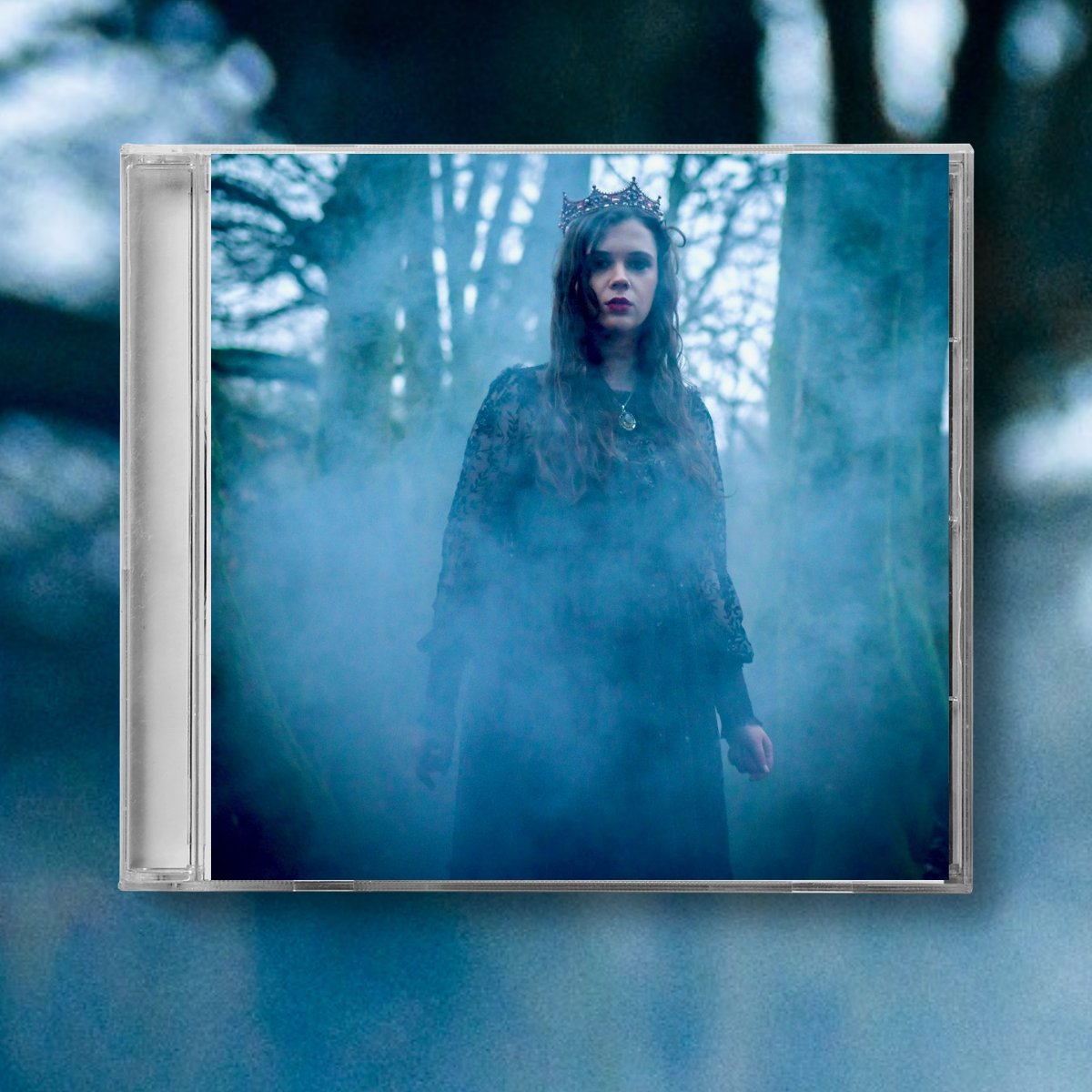 Ria's cover for Favourite Child EP - A woman wearing a crown and dark clothing stands in a foggy, forested area with tall trees in the background.
