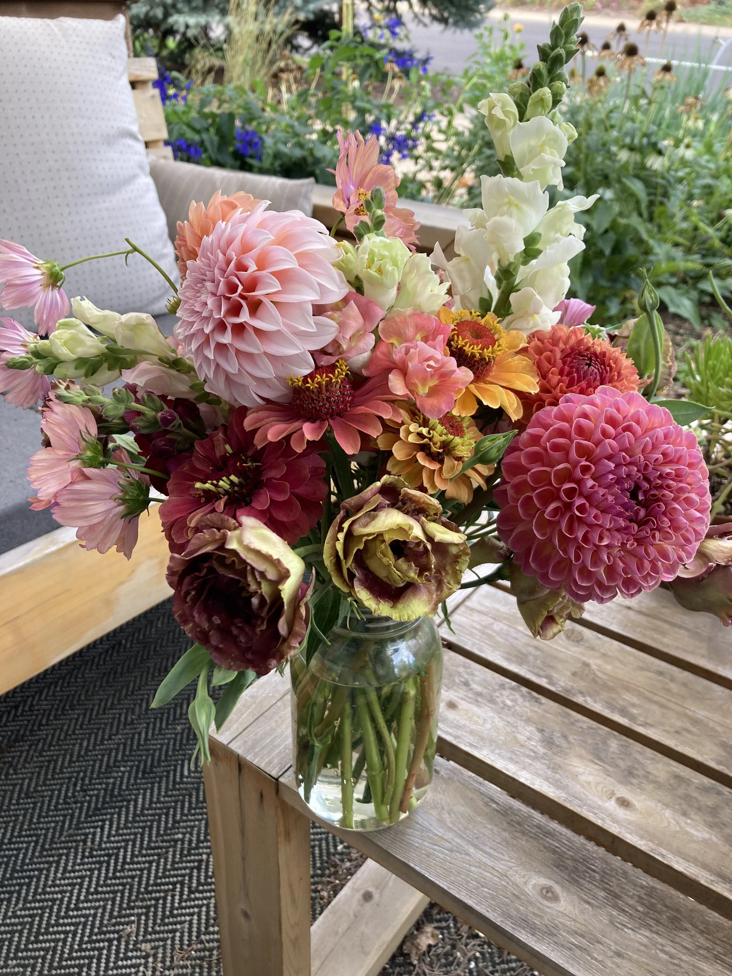 a vase full of fall flowers dahlias, lisianthus, zinnias