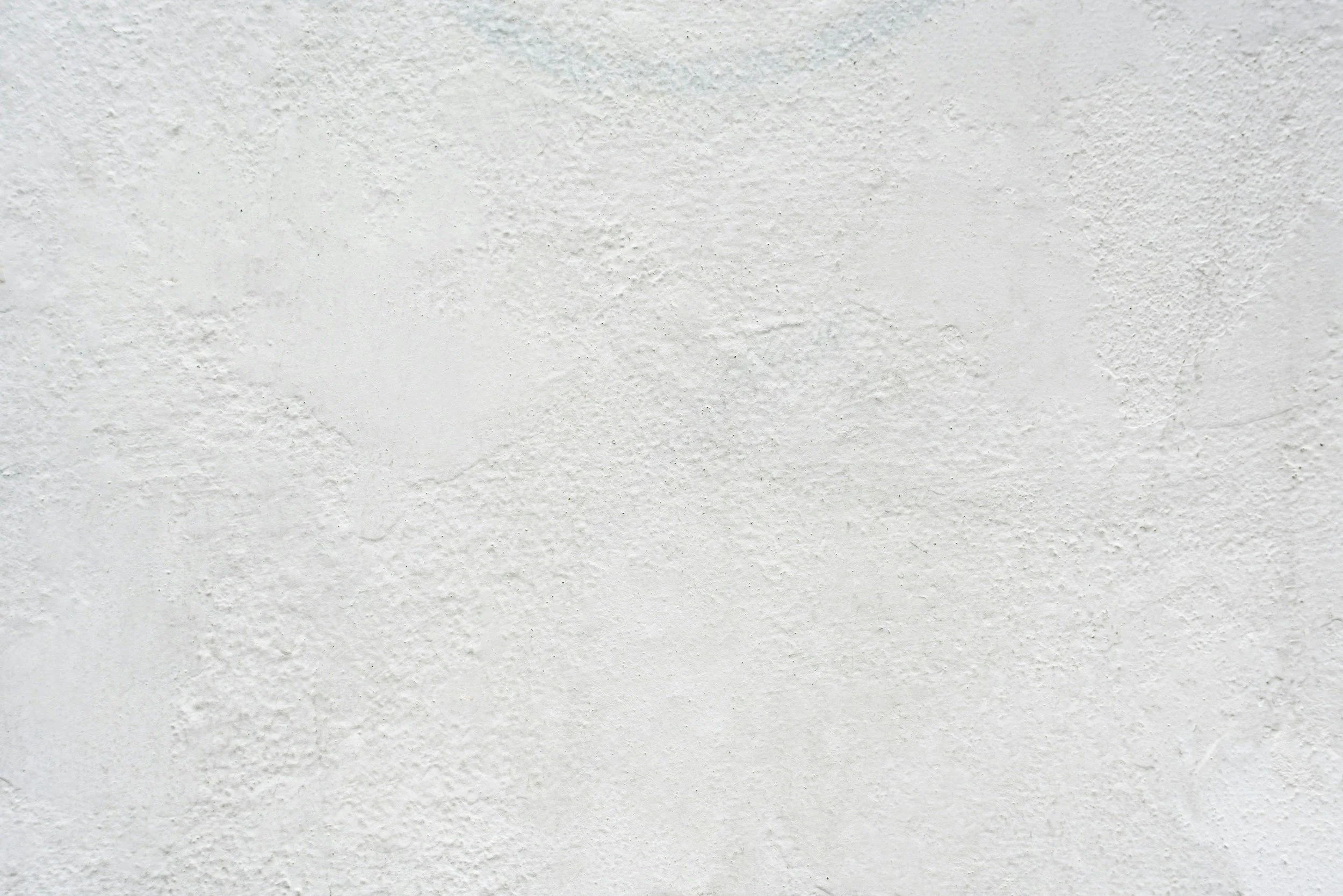 Blank white textured wall.