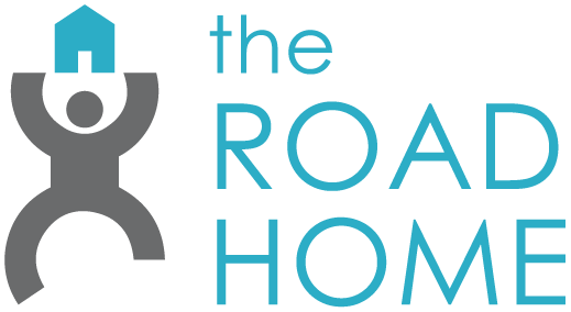 Logo for The Road Home organization with a stylized person holding a house symbol, and the text 'The Road Home' in teal and gray colors.