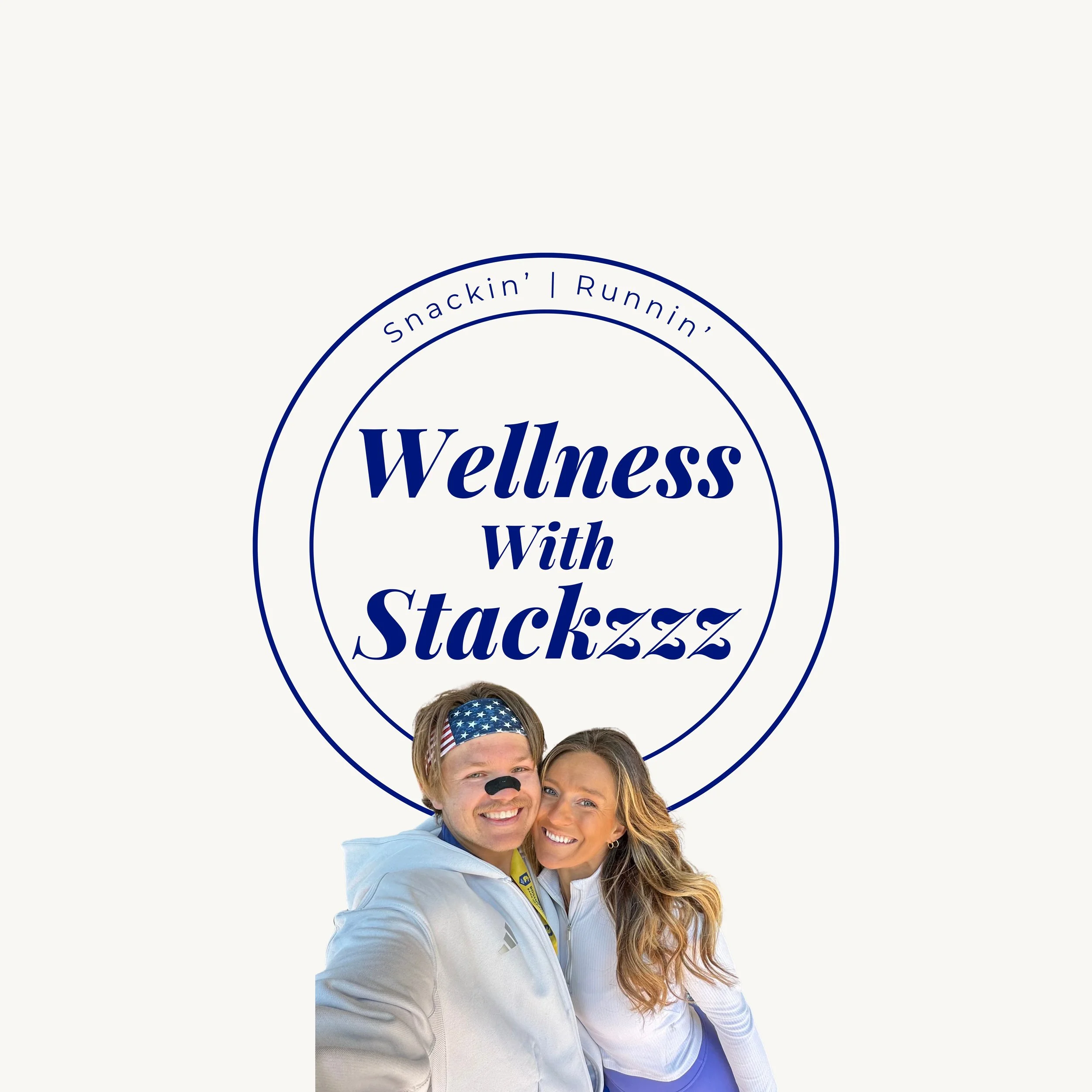 A logo with the text "Wellness with Stackzz" surrounded by the phrases "Snackin' | Runnin'" at the top and bottom. The logo features a smiling man wearing a headband with American flag design, with a small black nose painted on his face, and a smiling woman with long wavy hair.