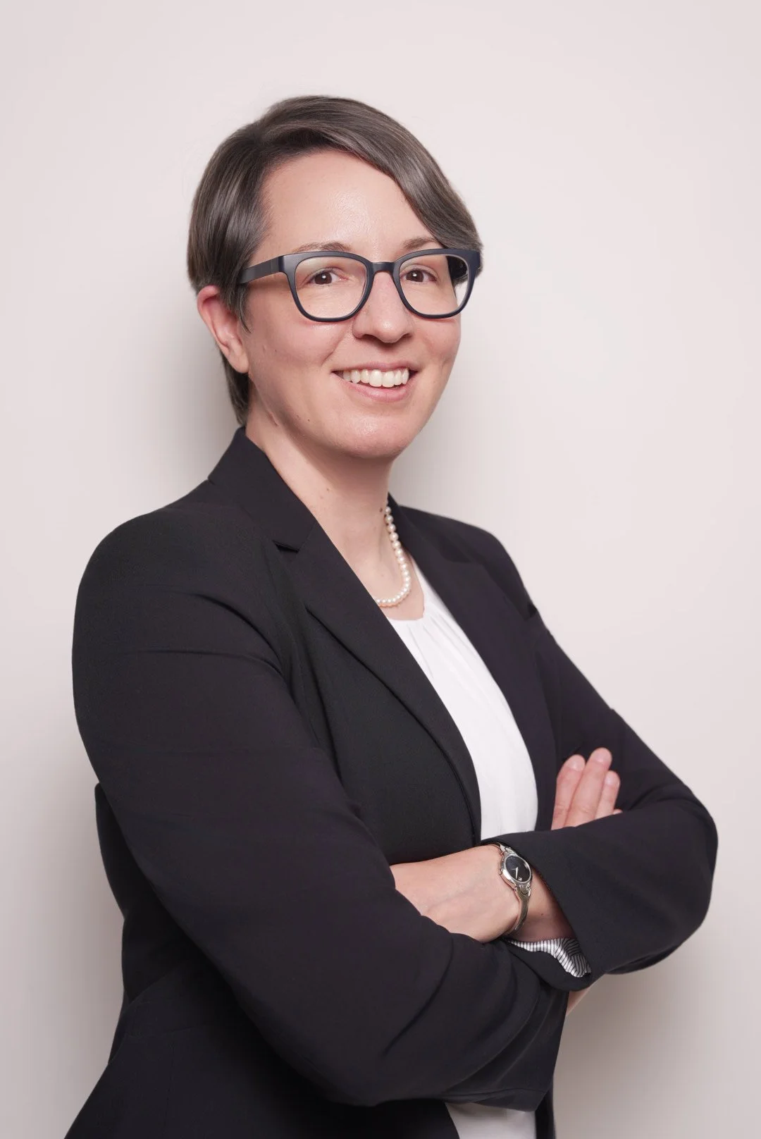 A female attorney standing with her arms folded ready to represent client sin social security disability.