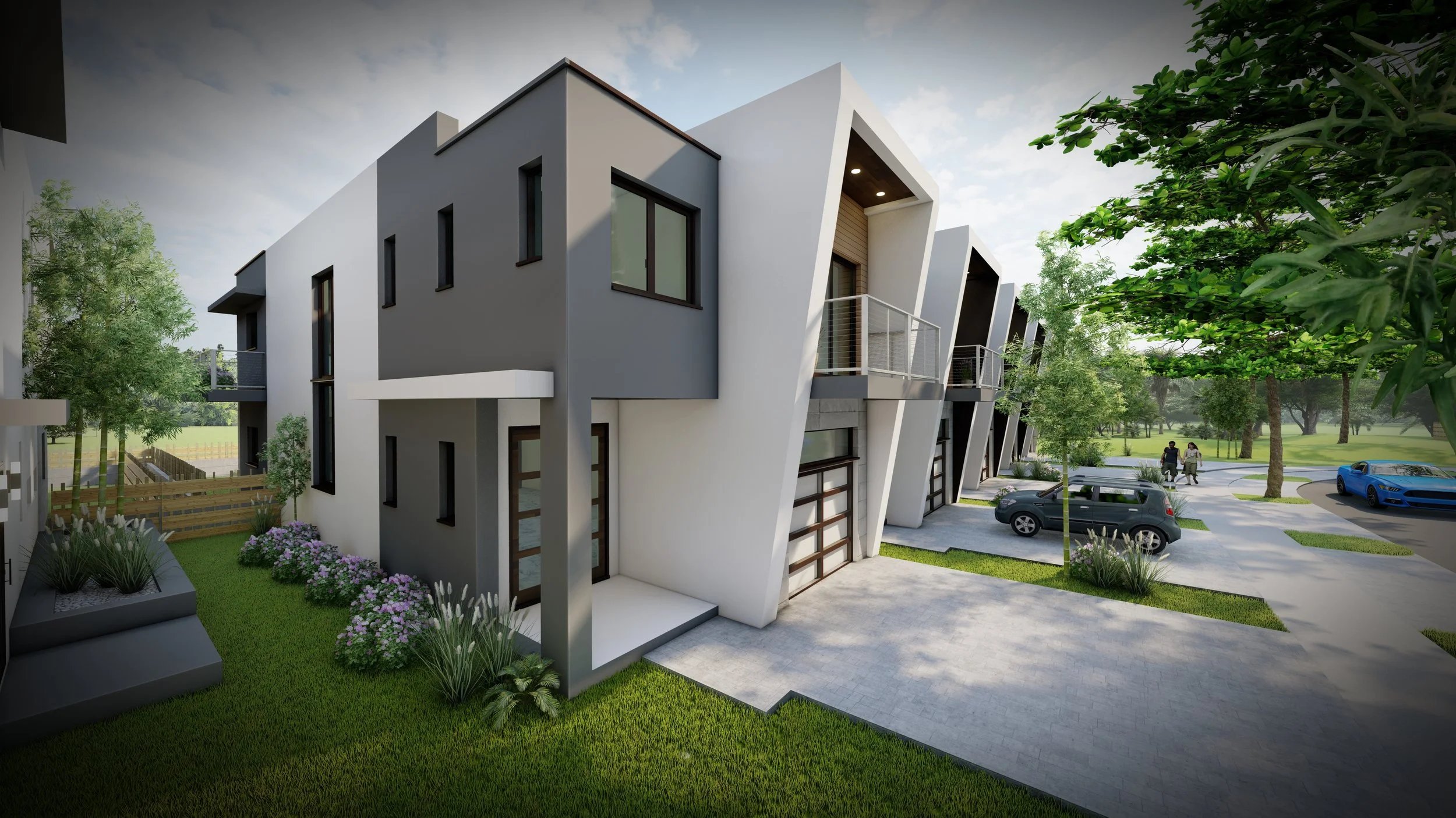 Modern townhouse complex with angular white and gray facades, small balconies, and a landscaped yard with grass, plants, and flowers. Cars are parked in the driveway, and a park with trees and walking paths is in the background.