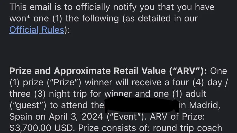 Close-up of a digital screen displaying an email notification about a prize won, with details about the prize, schedule, and estimated retail value.