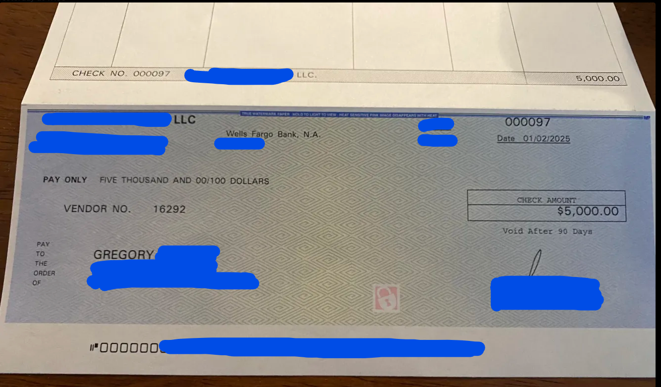 Photograph of a check from Wells Fargo Bank made payable to Gregory for five thousand dollars, dated January 2, 2025, with a handwritten signature and some information obscured in blue.