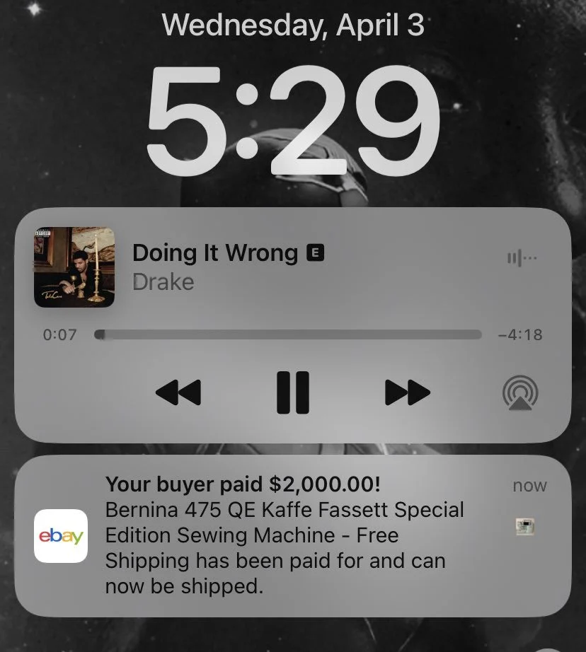A smartphone lock screen showing the time as 5:29 on April 3rd, with a music player playing Drake's song "Doing It Wrong," and a notification about a $2,000 eBay payment for a sewing machine.