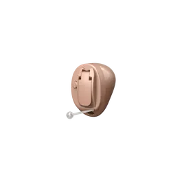 A beige-colored hearing aid with a remote control attached, placed against a black background.