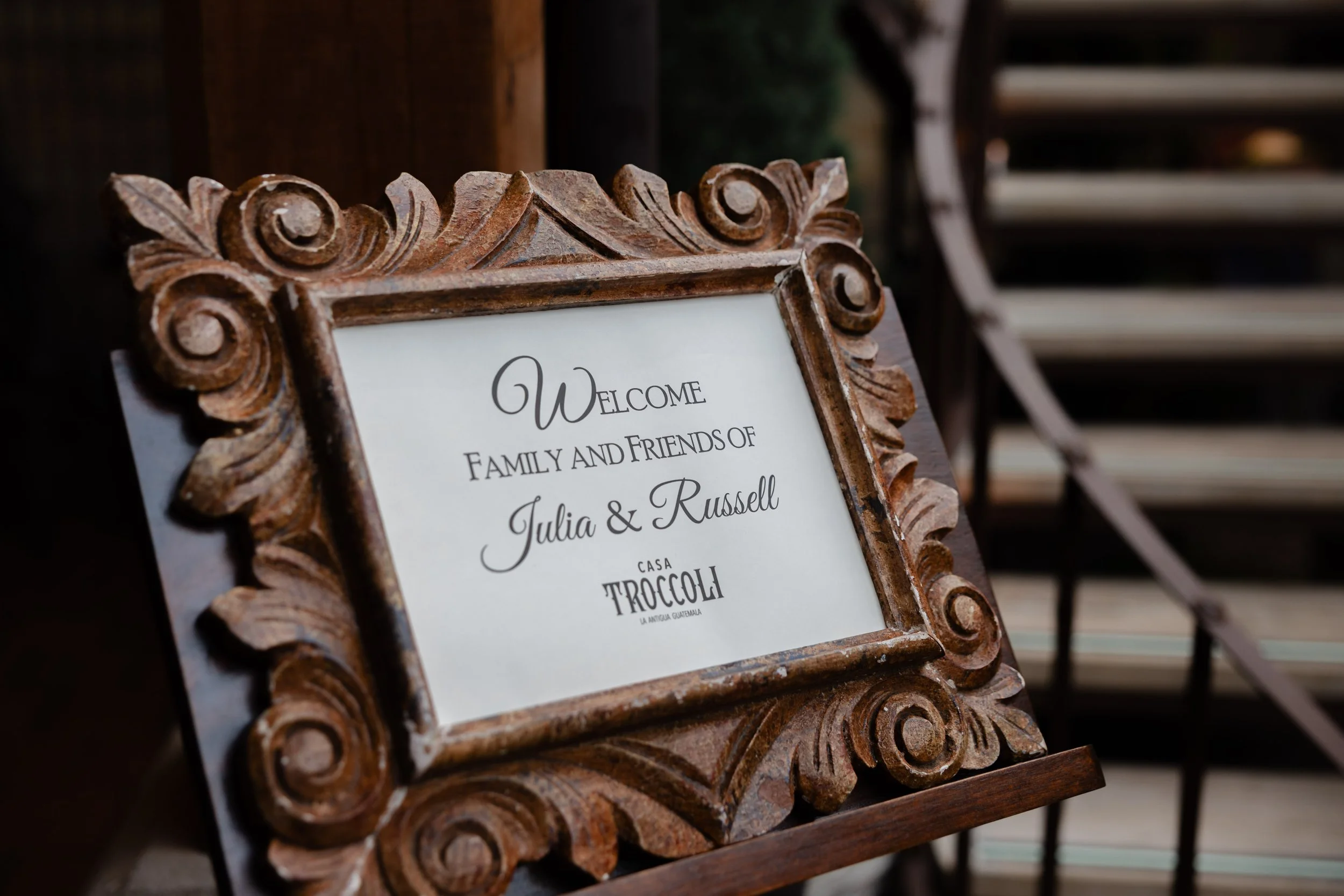Decorative wooden framed sign welcoming guests to Julia and Russell's wedding at Casa Troccoli in Guatemala.