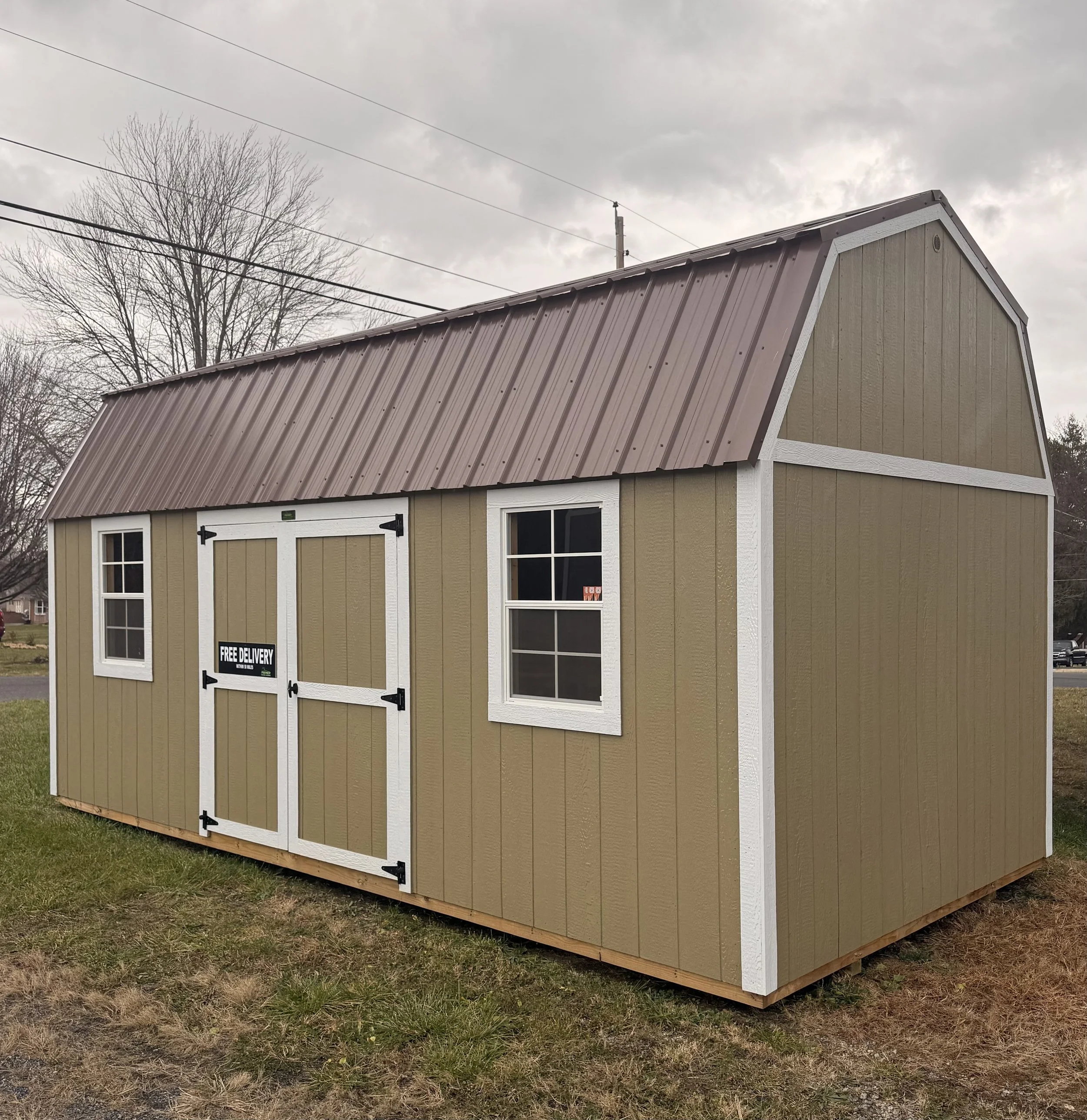 10×20 Natural Clay side lofted shed with double doors and overhead loft storage and two windows.