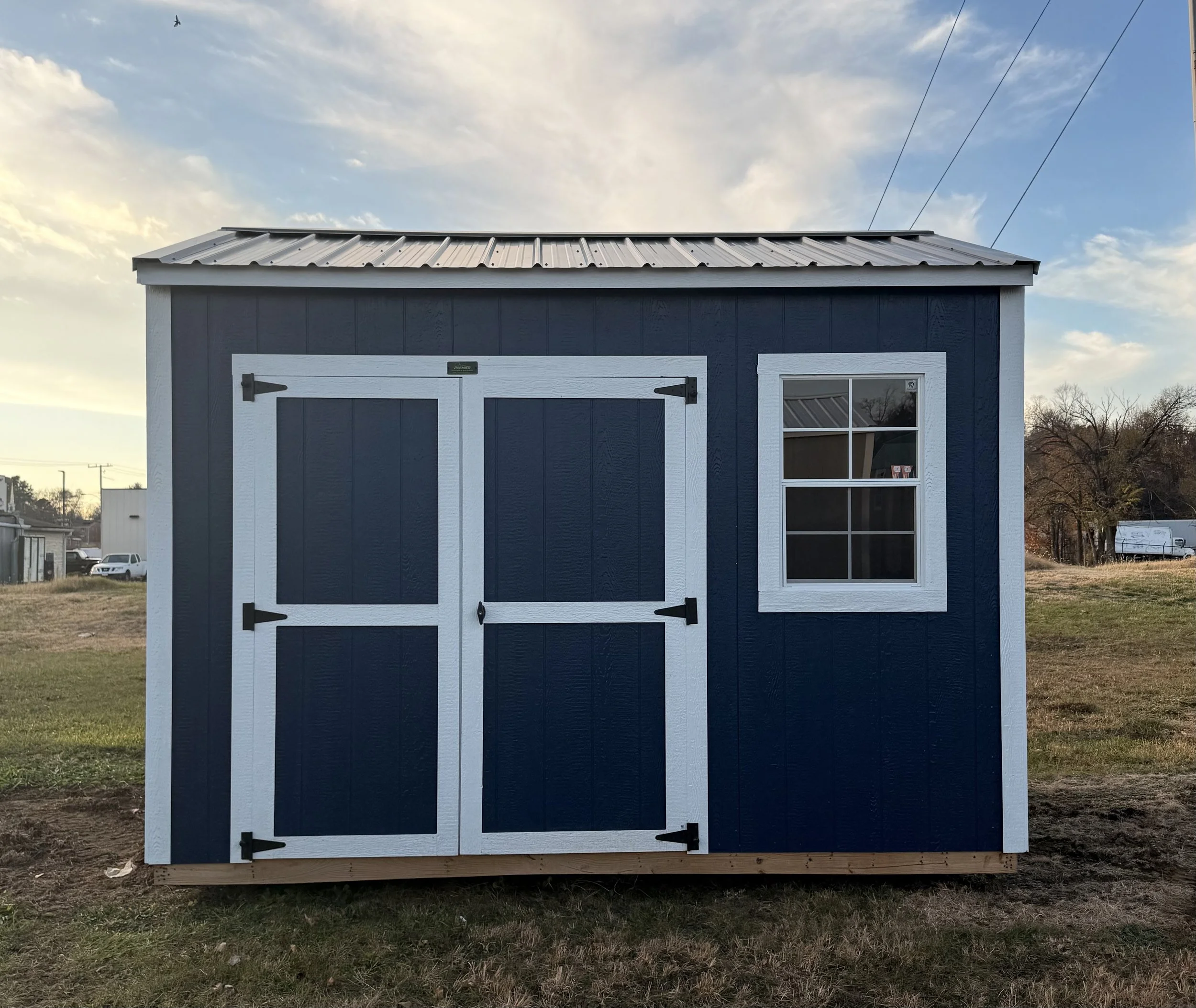 8×12 navy blue utility shed with a side window and simple, compact design.