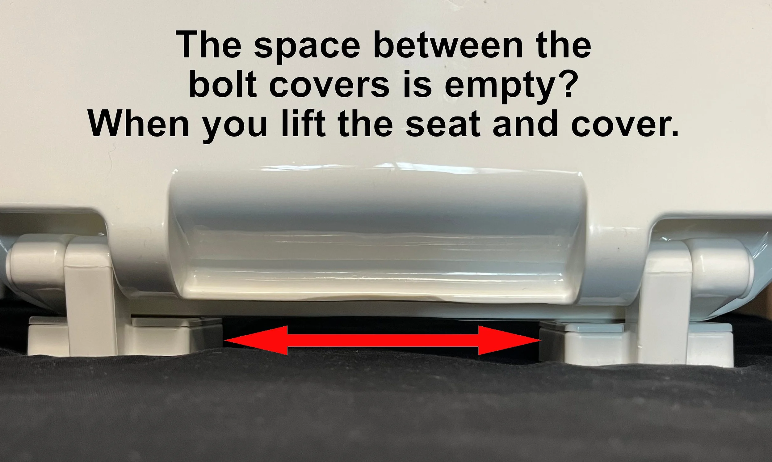 Close-up of the back of a toilet seat showing the space between the bolt covers, with an overlay text explaining that if lifting the seat and cover reveals this space, the Bowl Tie will fit.