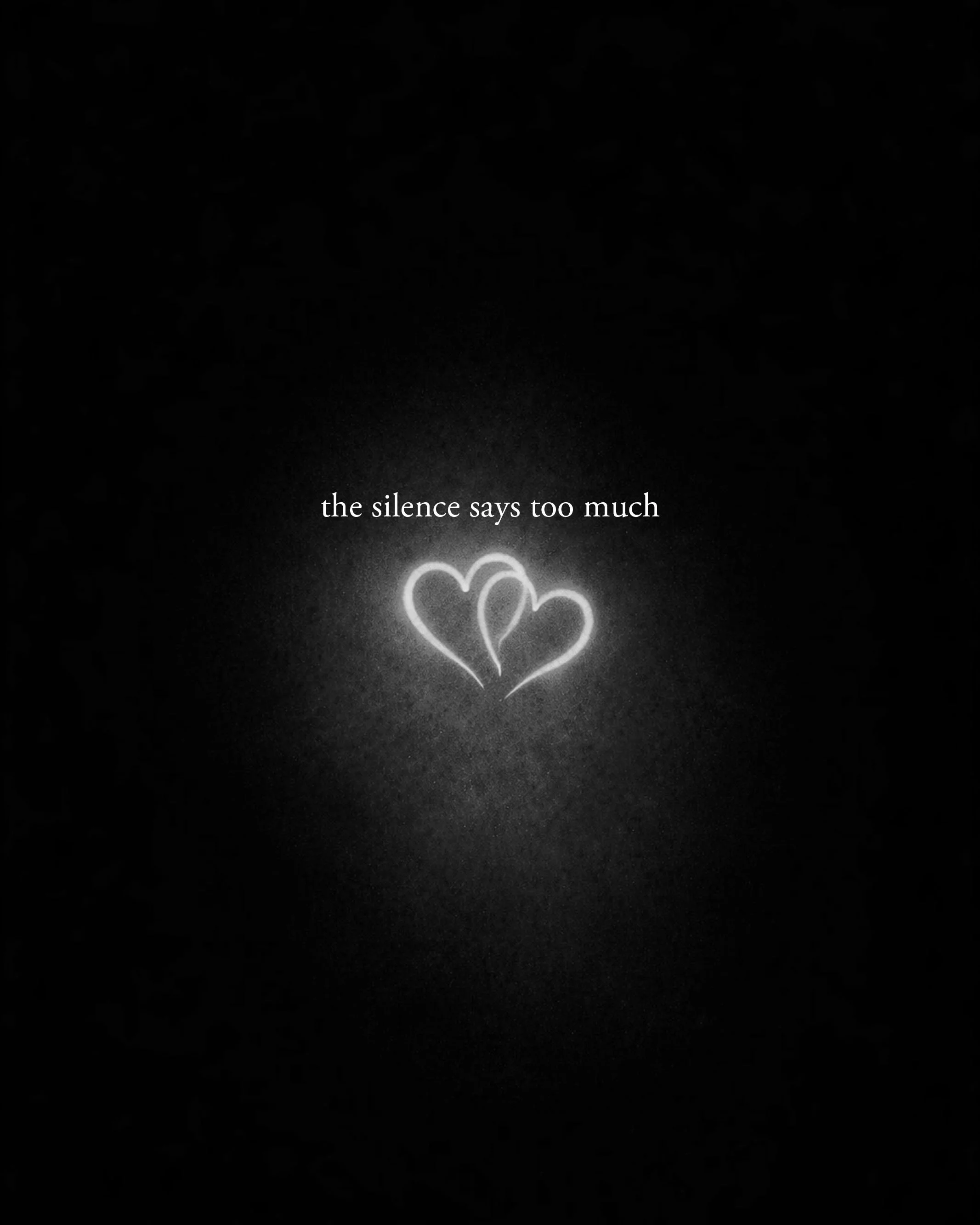 Dark background with three illuminated hearts and the phrase "the silence says too much" written in white text.