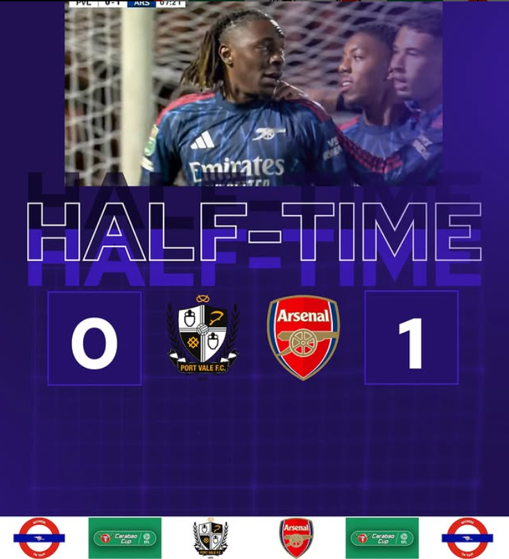 Soccer scoreboard showing halftime with Port Vale F.C. 0 and Arsenal 1, with players celebrating in the background.