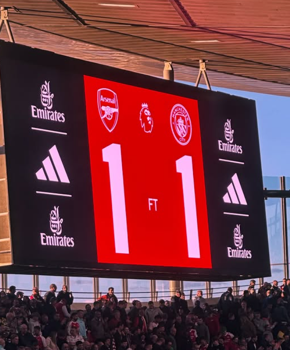 Large digital scoreboard showing the final score 1-1 of a soccer match between Arsenal and Crystal Palace, with sponsor Emirates logos and the stadium filled with spectators.