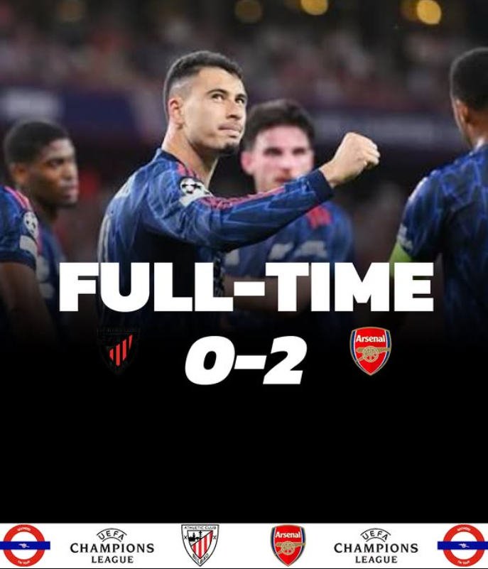 Soccer players with a full-time score of 0-2, Arsenal winning. The background shows a stadium, and the players are wearing blue jerseys.