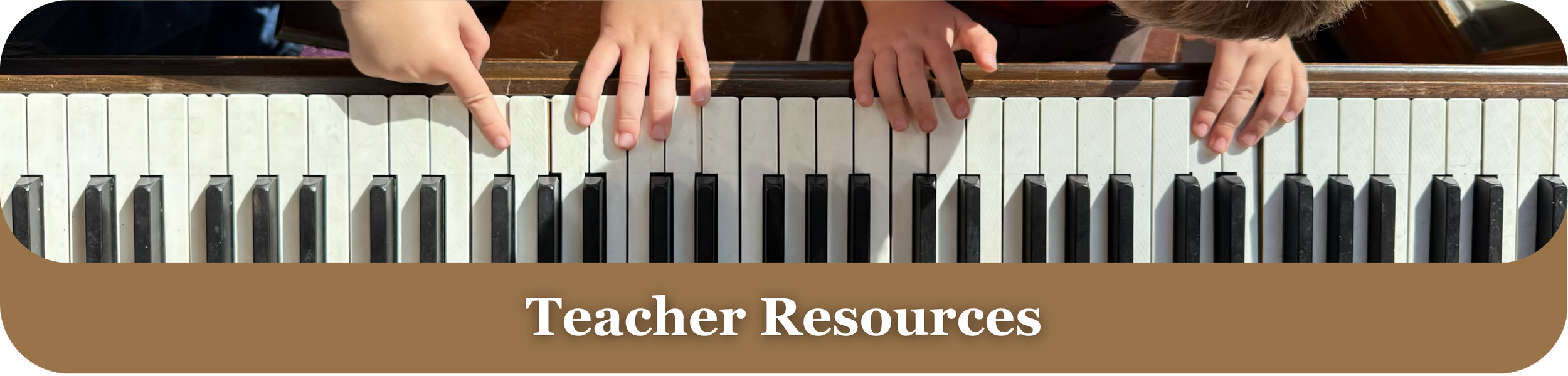 Top view of two children's hands playing a piano, with a label saying 'Teacher Resources' at the bottom.