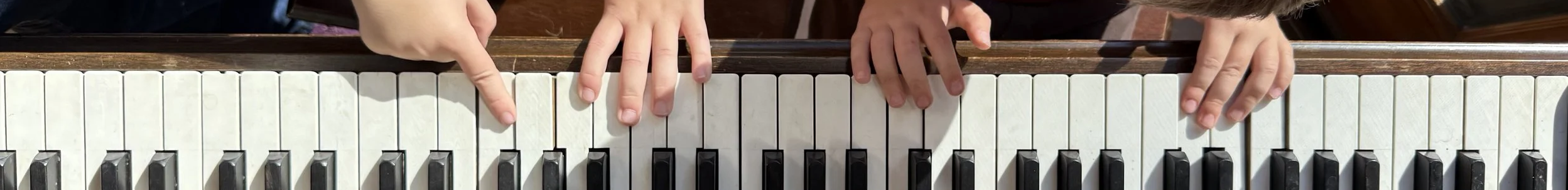 Little hands playing a big piano.