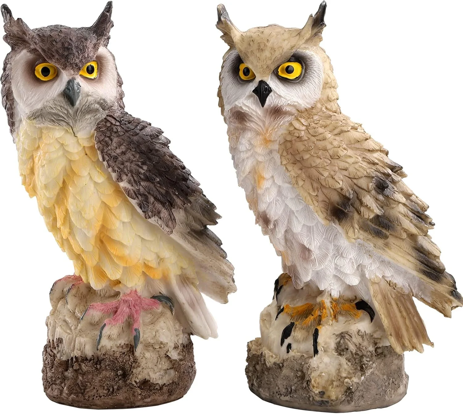 Two owl figurines made of carved and painted wood or resin, with detailed feathers, large yellow eyes, and perched on rocky bases.