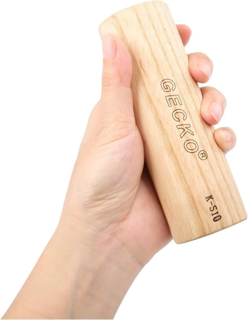Hand holding a wooden Gecko cylindrical wooden sand shaker on a white background.