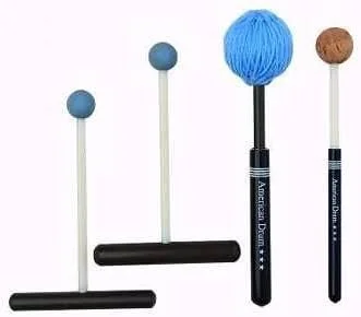 A set of percussion mallets with different tips, including a short handle with large blue yarn head, a short handle with a cork head, and two short T-grip handles with small hard rubber heads.
