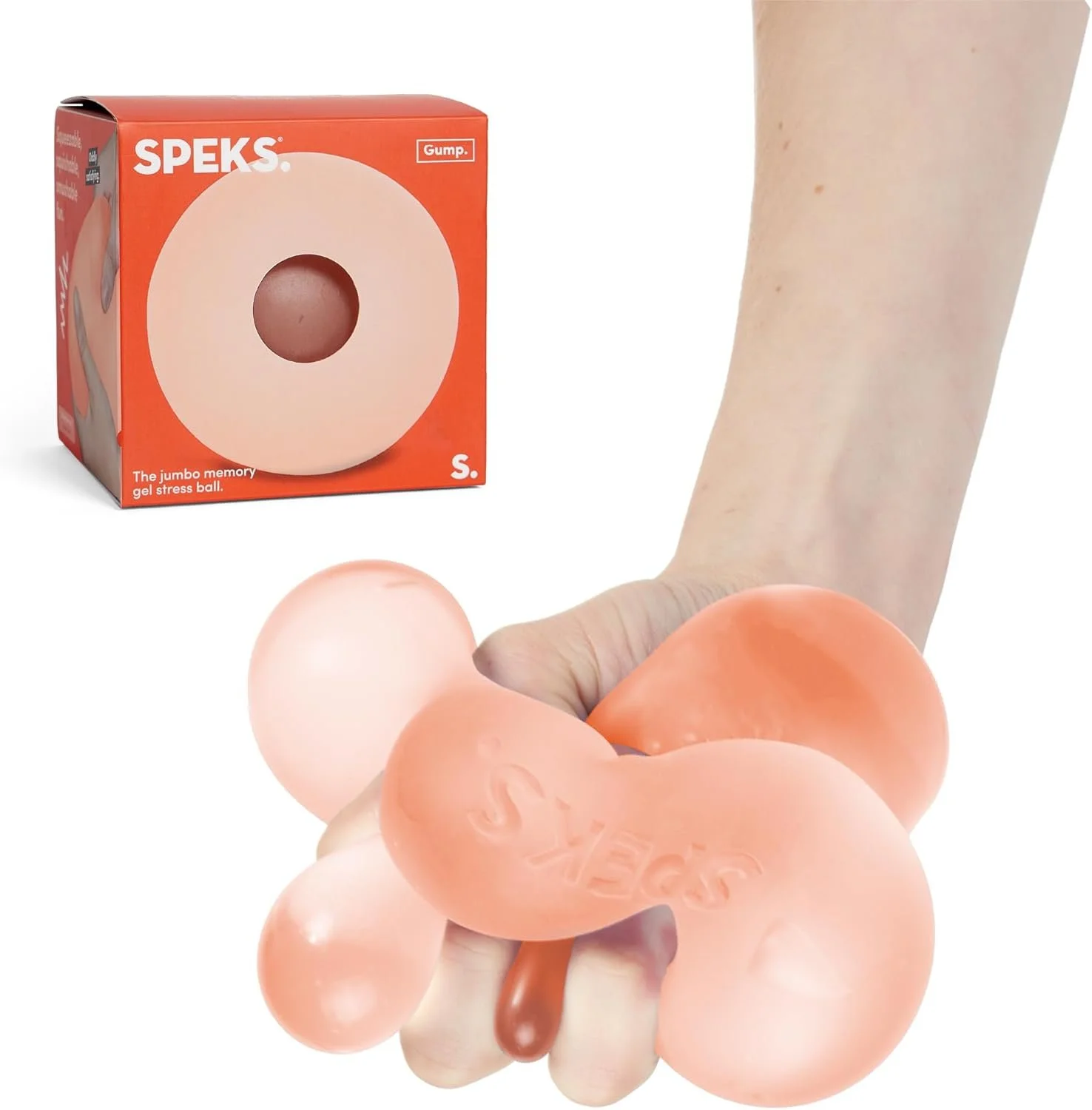 A hand holding a pink, balloon-like stress ball shaped like a cluster of connected spheres with the word Speks embossed on it. A box labeled 'Speks' and 'The jumbo memory gel stress ball' is in the background.
