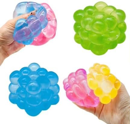 Colorful squeeze balls in blue, green, pink, and yellow, some being squeezed by hands.