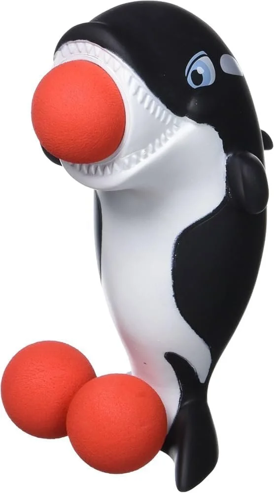 A shark-shaped toy with a large red nose and two red balls at its base.