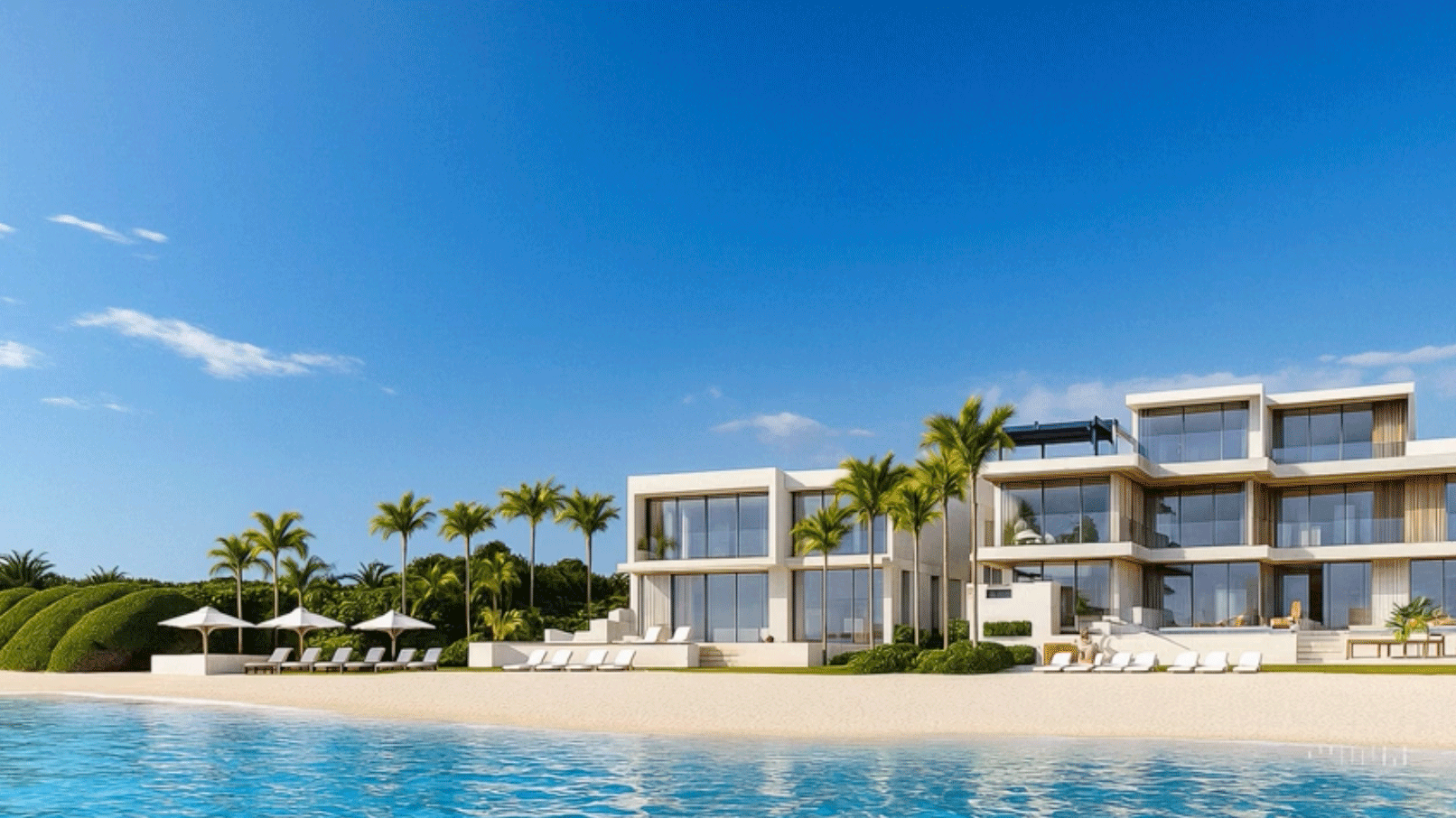 Luxury beachfront resort with modern architecture, multiple glass-walled buildings, and white lounge chairs under umbrellas on the sandy beach, surrounded by palm trees, under a bright blue sky.