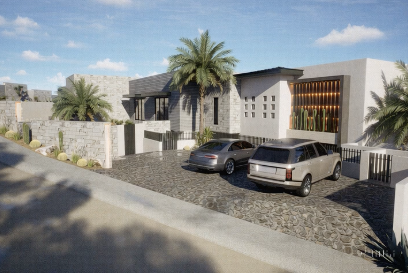 Modern house with white walls, palm trees, and cacti, featuring two parked cars on cobblestone driveway under blue sky with clouds.