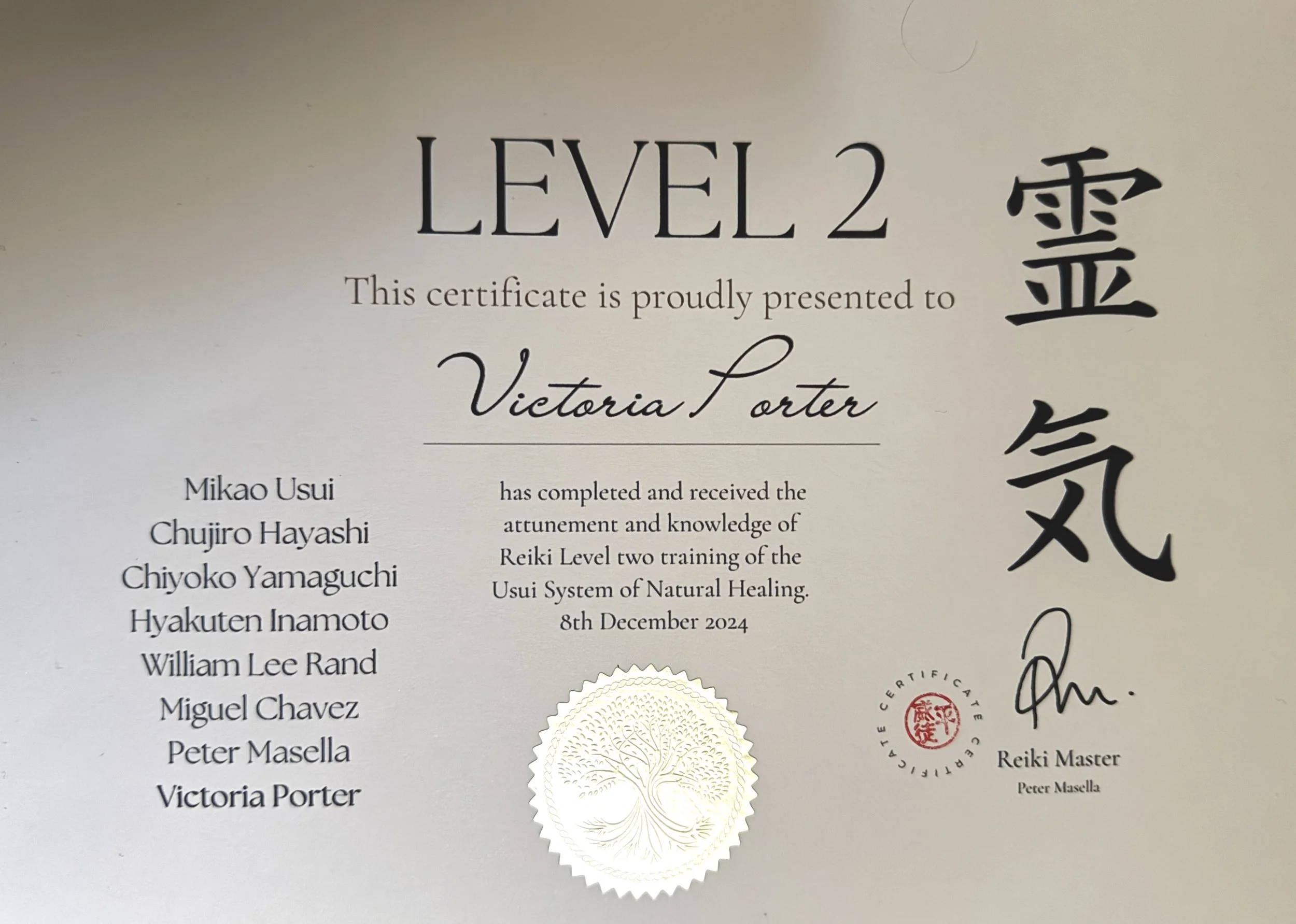 Certificate of Reiki Level 2 awarded to Victoria Porter, signed by Peter Masella, and featuring a gold seal and Japanese characters.