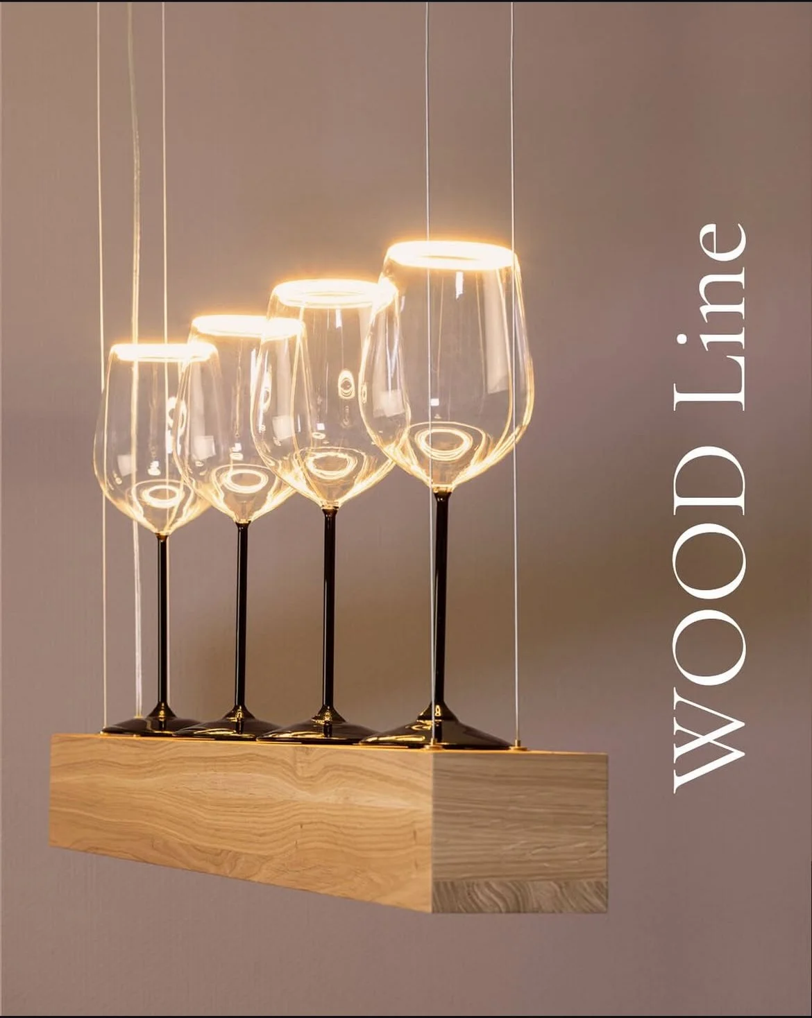 Set of four wine glasses with black stems on a wooden shelf, illuminated with warm lighting, with the text 'WOOD Line' running vertically on the right side.