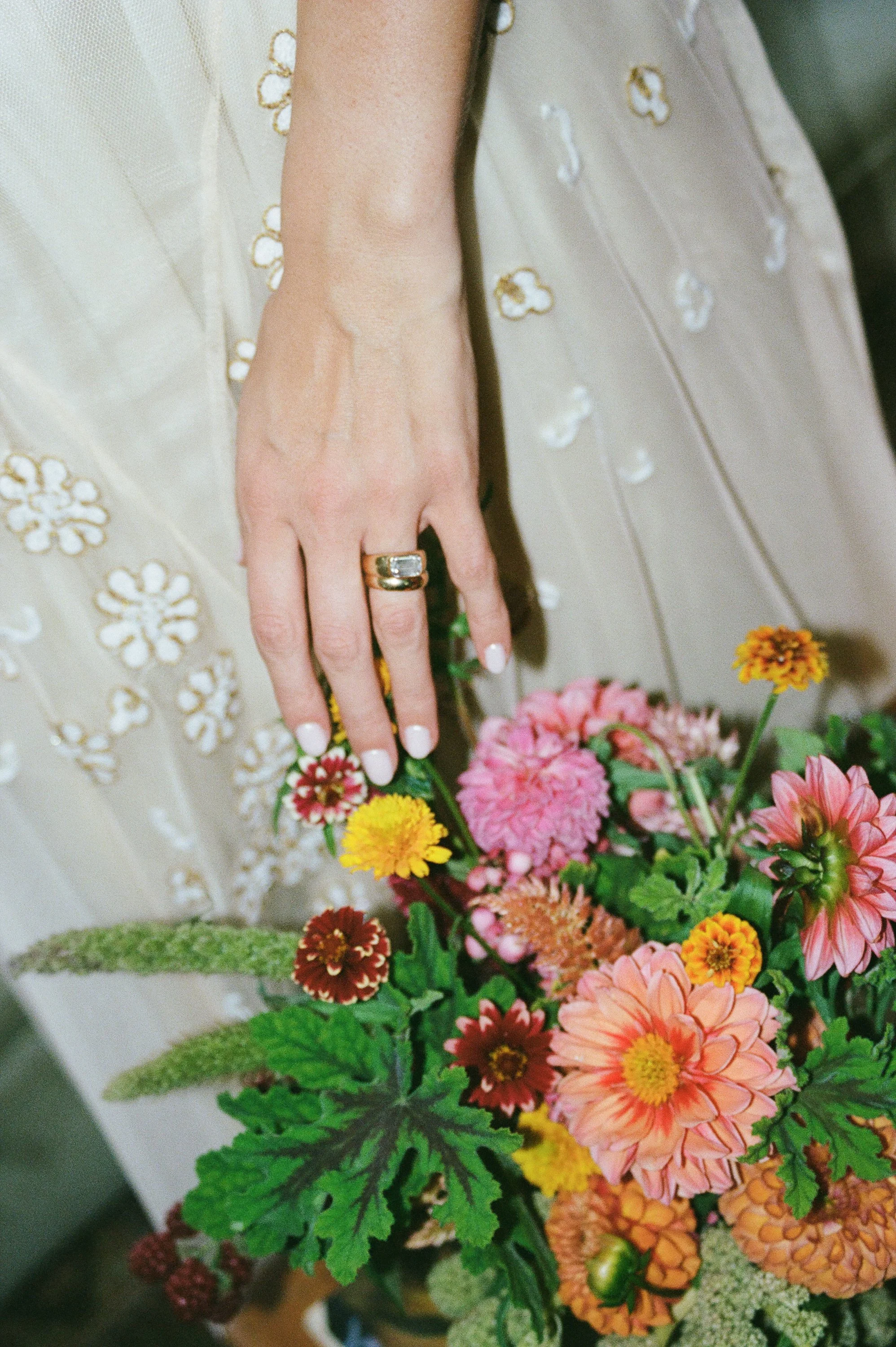 A romantic wedding floral still life featuring thoughtfully arranged blooms, delicate textures, and timeless botanical details. Fine-art wedding photography captured on film, highlighting the natural beauty, artistry, and thoughtful design of the wed