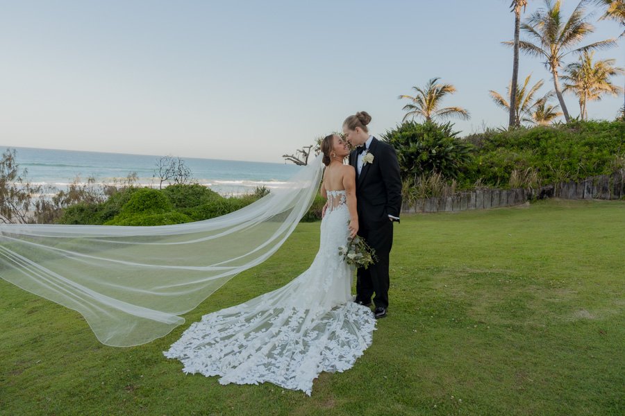 Brides in wedding dress at sunshine beach