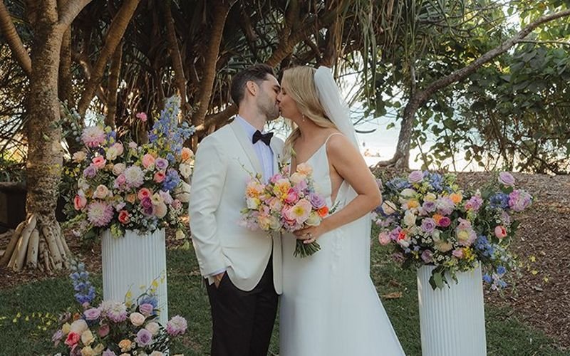 Kate & James kissing after wedding ceremony in Noosa near Main beach