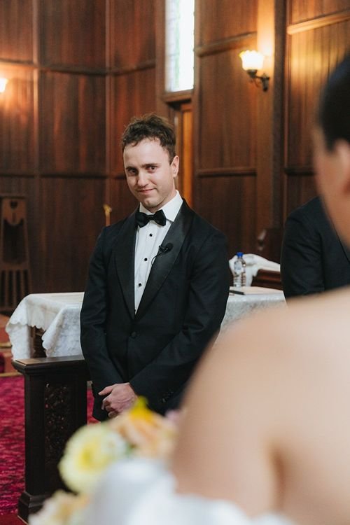 Groom looks with emotion in his face seeing his new bride for a first look. 